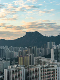 Buildings in city against sky during sunset