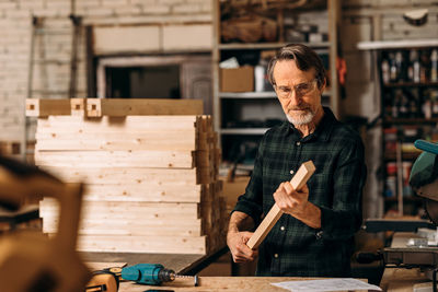 Portrait of man working on wood