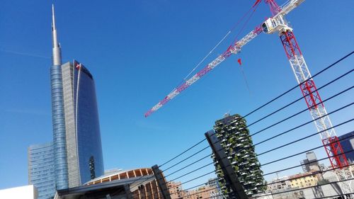 Low angle view of skyscraper against clear blue sky