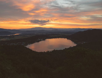 Scenic view of silhouette mountains against orange sky