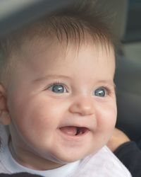 Close-up of cute baby girls looking away