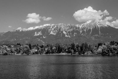 Scenic view of lake by trees against sky