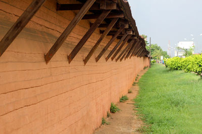 Footpath amidst buildings against sky