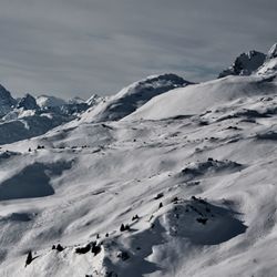 Scenic view of snow covered mountains against sky