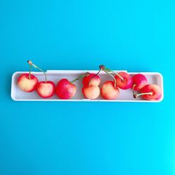 Close-up of apples on table against blue background