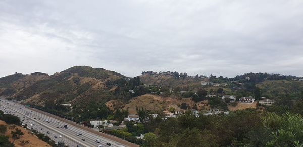 High angle view of road by townscape against sky