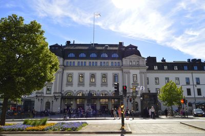 Buildings in city against cloudy sky