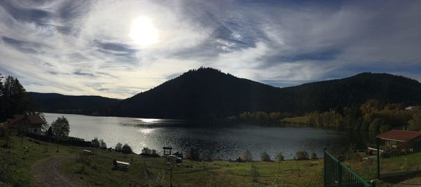 Scenic view of river and mountains against sky