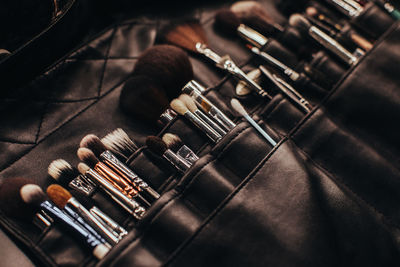 A set of makeup artist brushes in a black case