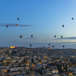 Hot air balloons fly at sunrise