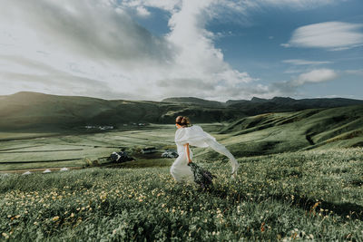 Woman on field against sky