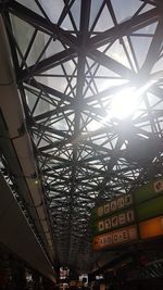 Low angle view of railroad station against sky