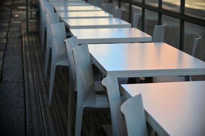 Empty chairs and tables in restaurant terrace