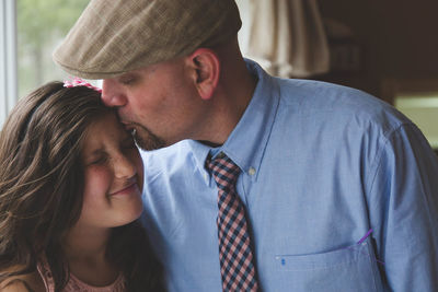 Close-up of father kissing daughter