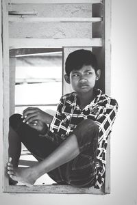 Portrait of young man sitting at home