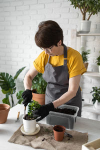 Side view of man gardening at home