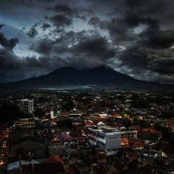 Cityscape against cloudy sky