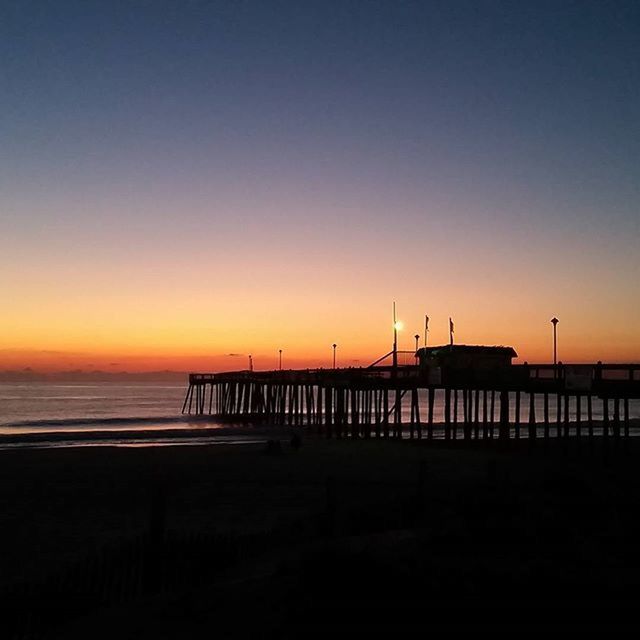 sunset, sea, water, beach, horizon over water, orange color, tranquil scene, scenics, copy space, tranquility, silhouette, beauty in nature, pier, clear sky, nature, idyllic, shore, sky, incidental people, dusk