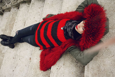 High angle view of woman lying down on staircase