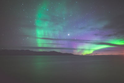Scenic view of landscape against sky at night