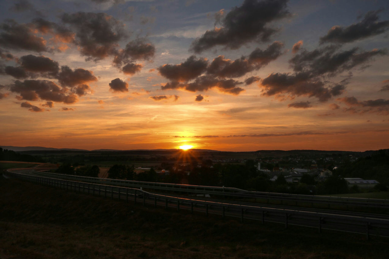 ROAD AGAINST SKY DURING SUNSET