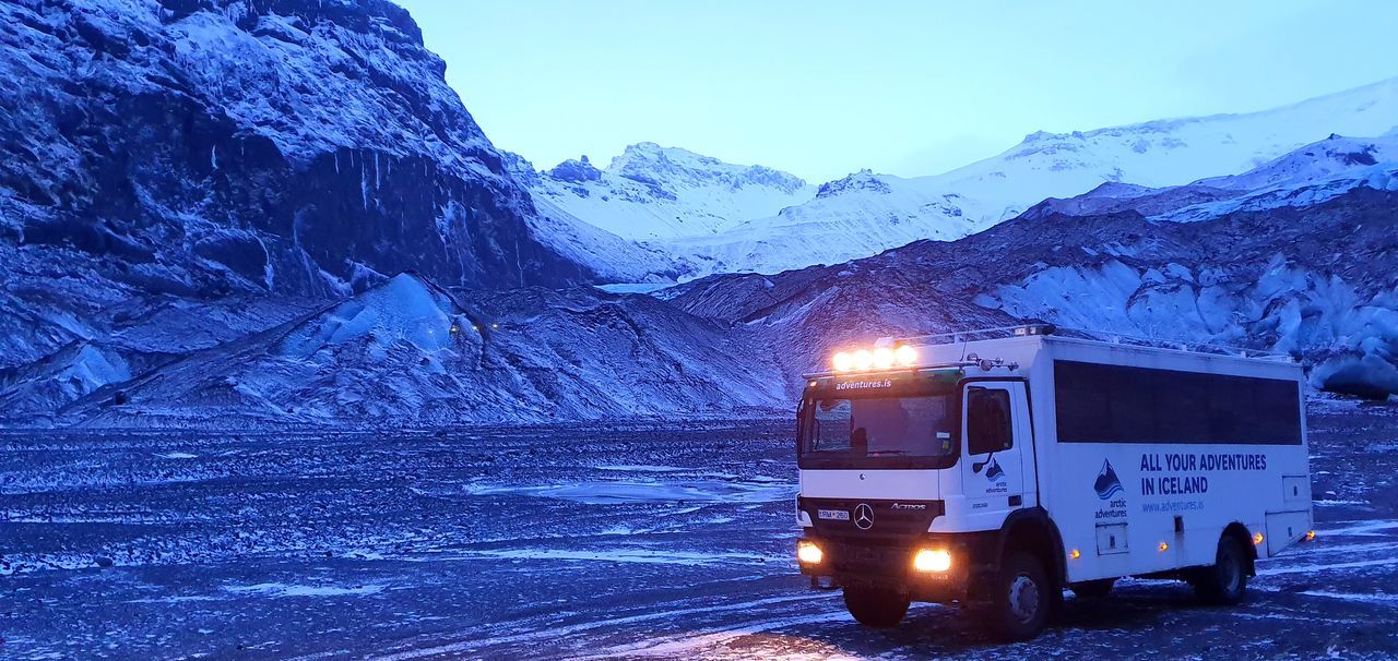 cold temperature, winter, mountain, snow, mode of transportation, transportation, land vehicle, mountain range, scenics - nature, snowcapped mountain, illuminated, sky, nature, beauty in nature, frozen, non-urban scene, no people, travel, environment, extreme weather