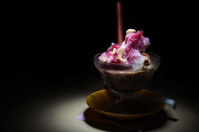 Close-up of ice cream cone against black background