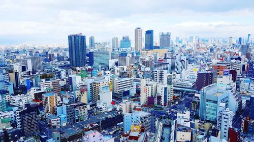 Aerial view of cityscape against sky