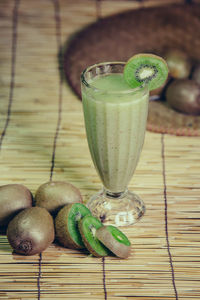 Close-up of drink with kiwis on table