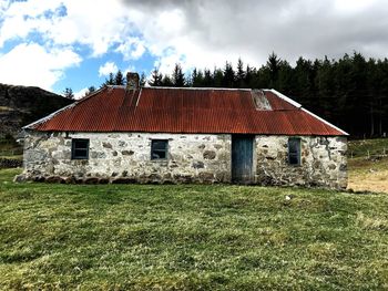 House on field against sky