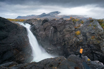 Scenic view of waterfall against sky