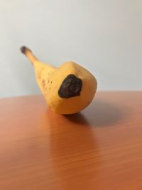 Close-up of apple on table against white background