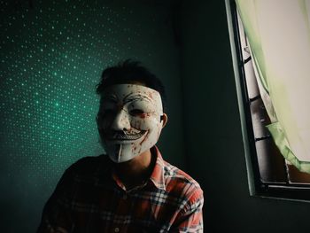 Portrait of man in window at night
