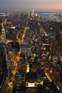 Aerial view of illuminated city buildings at night