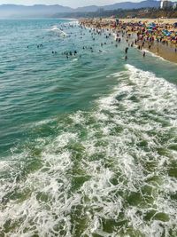 People at beach against sky