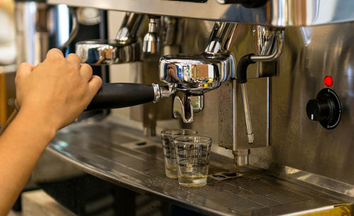 Midsection of man having coffee at cafe