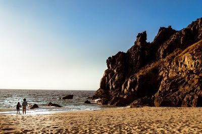 Scenic view of beach against clear sky