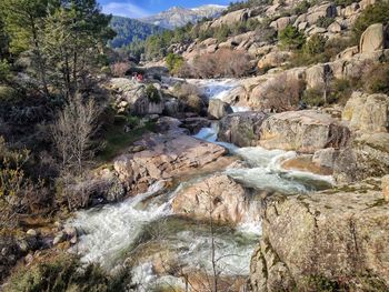 View of stream flowing through rocks