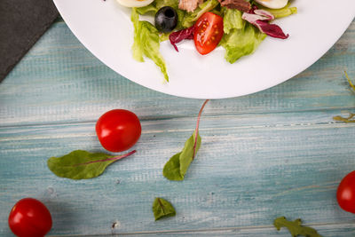 High angle view of tomatoes and fruits on table
