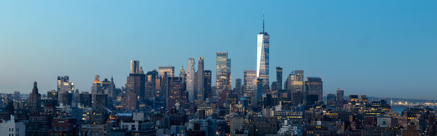 Modern buildings in city against clear sky