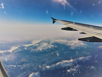 Aerial view of aircraft wing against sky