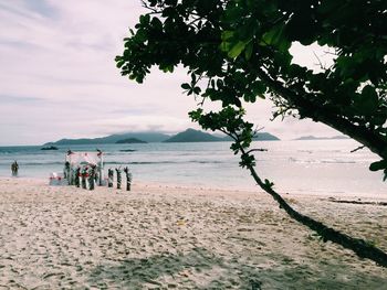 People on beach against sky