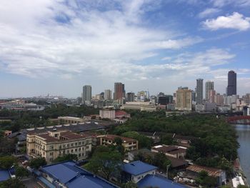 Buildings against cloudy sky