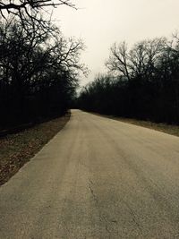 Road amidst trees against sky