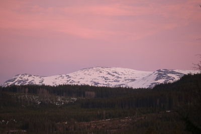 Scenic view of snowcapped mountains against sky during sunset