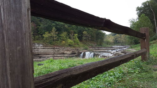 Wooden fence on grassy landscape