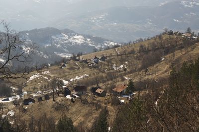 High angle view of trees and buildings against mountains