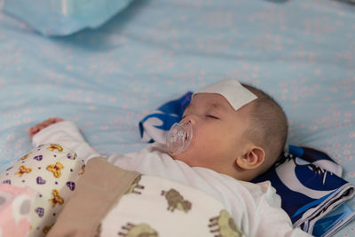 Portrait of cute baby lying on bed