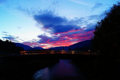 Scenic view of silhouette mountains against sky at sunset