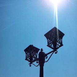 Low angle view of street light against clear blue sky